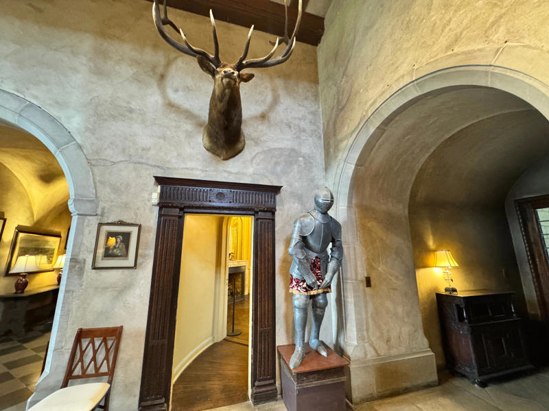 There are personalized touches all over the house's limestone exterior., It took three years to complete Coe Hall., One of the first rooms you can view is Coe's den., It's covered in dark wood, giving a masculine atmosphere., The art in the living room is original to the home., It's certainly not a bad place to spend your weekends., The craftsmanship throughout the house was impossible to miss., There was another portrait of Coe hanging in the corner., The main staircase felt straight out of a castle., And no, that's not wallpaper. This design was hand-painted onto the wall., The windows gave her a view of the gardens she painstakingly designed., This is her bathroom. Once again, it's very French., Now it was time to check out the much-revered grounds., Right off the bat, this fountain caught my eye., Can't you just hear someone saying, "Once upon a time…"?, Rogers entertained her friends in the Tea House on nice days., It looks like the inside of a Tiffany's box., Walking through it felt like walking through a storybook., One corner of the building was anchored by this giant palm tree., It has the largest collection of camellias under glass in the northeast., However, camellia season is in January, so we missed it.