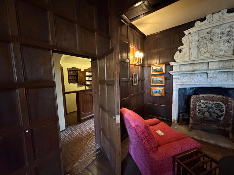 There are personalized touches all over the house's limestone exterior., It took three years to complete Coe Hall., One of the first rooms you can view is Coe's den., It's covered in dark wood, giving a masculine atmosphere., The art in the living room is original to the home., It's certainly not a bad place to spend your weekends., The craftsmanship throughout the house was impossible to miss., There was another portrait of Coe hanging in the corner., The main staircase felt straight out of a castle., And no, that's not wallpaper. This design was hand-painted onto the wall., The windows gave her a view of the gardens she painstakingly designed., This is her bathroom. Once again, it's very French., Now it was time to check out the much-revered grounds., Right off the bat, this fountain caught my eye., Can't you just hear someone saying, "Once upon a time…"?, Rogers entertained her friends in the Tea House on nice days., It looks like the inside of a Tiffany's box., Walking through it felt like walking through a storybook., One corner of the building was anchored by this giant palm tree., It has the largest collection of camellias under glass in the northeast., However, camellia season is in January, so we missed it.