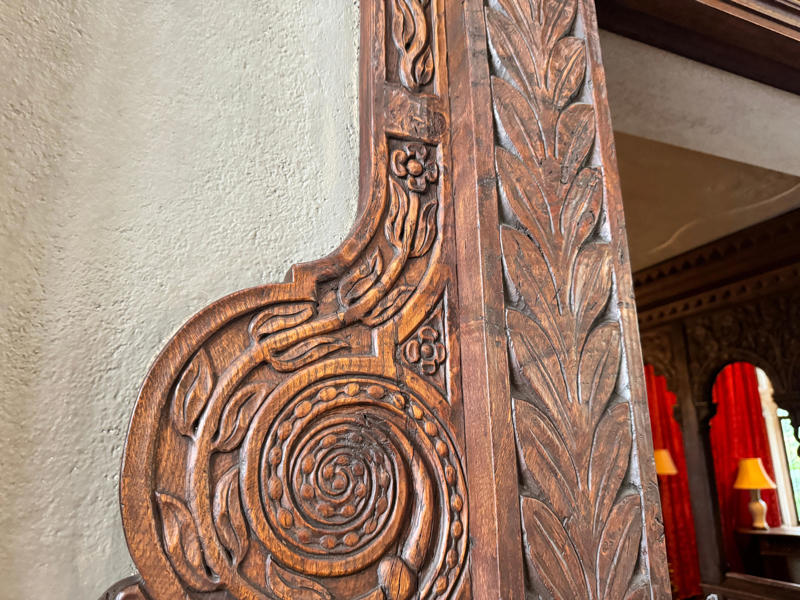 There are personalized touches all over the house's limestone exterior., It took three years to complete Coe Hall., One of the first rooms you can view is Coe's den., It's covered in dark wood, giving a masculine atmosphere., The art in the living room is original to the home., It's certainly not a bad place to spend your weekends., The craftsmanship throughout the house was impossible to miss., There was another portrait of Coe hanging in the corner., The main staircase felt straight out of a castle., And no, that's not wallpaper. This design was hand-painted onto the wall., The windows gave her a view of the gardens she painstakingly designed., This is her bathroom. Once again, it's very French., Now it was time to check out the much-revered grounds., Right off the bat, this fountain caught my eye., Can't you just hear someone saying, "Once upon a time…"?, Rogers entertained her friends in the Tea House on nice days., It looks like the inside of a Tiffany's box., Walking through it felt like walking through a storybook., One corner of the building was anchored by this giant palm tree., It has the largest collection of camellias under glass in the northeast., However, camellia season is in January, so we missed it.