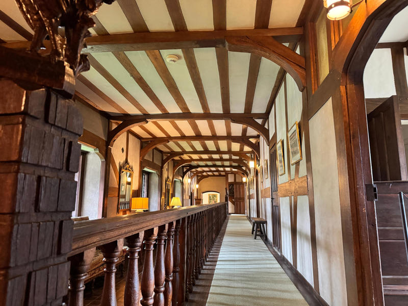 There are personalized touches all over the house's limestone exterior., It took three years to complete Coe Hall., One of the first rooms you can view is Coe's den., It's covered in dark wood, giving a masculine atmosphere., The art in the living room is original to the home., It's certainly not a bad place to spend your weekends., The craftsmanship throughout the house was impossible to miss., There was another portrait of Coe hanging in the corner., The main staircase felt straight out of a castle., And no, that's not wallpaper. This design was hand-painted onto the wall., The windows gave her a view of the gardens she painstakingly designed., This is her bathroom. Once again, it's very French., Now it was time to check out the much-revered grounds., Right off the bat, this fountain caught my eye., Can't you just hear someone saying, "Once upon a time…"?, Rogers entertained her friends in the Tea House on nice days., It looks like the inside of a Tiffany's box., Walking through it felt like walking through a storybook., One corner of the building was anchored by this giant palm tree., It has the largest collection of camellias under glass in the northeast., However, camellia season is in January, so we missed it.
