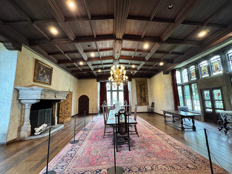 There are personalized touches all over the house's limestone exterior., It took three years to complete Coe Hall., One of the first rooms you can view is Coe's den., It's covered in dark wood, giving a masculine atmosphere., The art in the living room is original to the home., It's certainly not a bad place to spend your weekends., The craftsmanship throughout the house was impossible to miss., There was another portrait of Coe hanging in the corner., The main staircase felt straight out of a castle., And no, that's not wallpaper. This design was hand-painted onto the wall., The windows gave her a view of the gardens she painstakingly designed., This is her bathroom. Once again, it's very French., Now it was time to check out the much-revered grounds., Right off the bat, this fountain caught my eye., Can't you just hear someone saying, "Once upon a time…"?, Rogers entertained her friends in the Tea House on nice days., It looks like the inside of a Tiffany's box., Walking through it felt like walking through a storybook., One corner of the building was anchored by this giant palm tree., It has the largest collection of camellias under glass in the northeast., However, camellia season is in January, so we missed it.