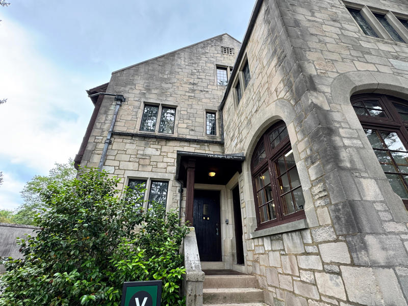 There are personalized touches all over the house's limestone exterior., It took three years to complete Coe Hall., One of the first rooms you can view is Coe's den., It's covered in dark wood, giving a masculine atmosphere., The art in the living room is original to the home., It's certainly not a bad place to spend your weekends., The craftsmanship throughout the house was impossible to miss., There was another portrait of Coe hanging in the corner., The main staircase felt straight out of a castle., And no, that's not wallpaper. This design was hand-painted onto the wall., The windows gave her a view of the gardens she painstakingly designed., This is her bathroom. Once again, it's very French., Now it was time to check out the much-revered grounds., Right off the bat, this fountain caught my eye., Can't you just hear someone saying, "Once upon a time…"?, Rogers entertained her friends in the Tea House on nice days., It looks like the inside of a Tiffany's box., Walking through it felt like walking through a storybook., One corner of the building was anchored by this giant palm tree., It has the largest collection of camellias under glass in the northeast., However, camellia season is in January, so we missed it.