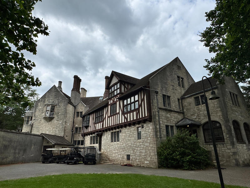 There are personalized touches all over the house's limestone exterior., It took three years to complete Coe Hall., One of the first rooms you can view is Coe's den., It's covered in dark wood, giving a masculine atmosphere., The art in the living room is original to the home., It's certainly not a bad place to spend your weekends., The craftsmanship throughout the house was impossible to miss., There was another portrait of Coe hanging in the corner., The main staircase felt straight out of a castle., And no, that's not wallpaper. This design was hand-painted onto the wall., The windows gave her a view of the gardens she painstakingly designed., This is her bathroom. Once again, it's very French., Now it was time to check out the much-revered grounds., Right off the bat, this fountain caught my eye., Can't you just hear someone saying, "Once upon a time…"?, Rogers entertained her friends in the Tea House on nice days., It looks like the inside of a Tiffany's box., Walking through it felt like walking through a storybook., One corner of the building was anchored by this giant palm tree., It has the largest collection of camellias under glass in the northeast., However, camellia season is in January, so we missed it.