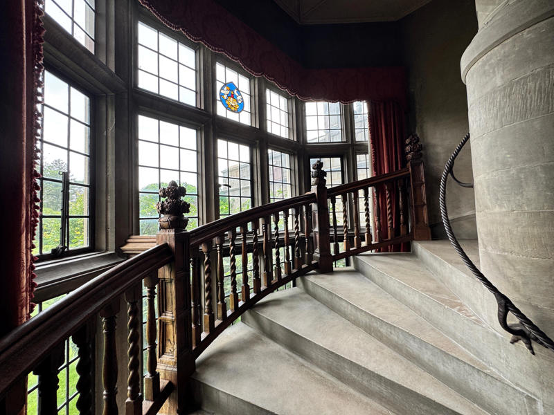 There are personalized touches all over the house's limestone exterior., It took three years to complete Coe Hall., One of the first rooms you can view is Coe's den., It's covered in dark wood, giving a masculine atmosphere., The art in the living room is original to the home., It's certainly not a bad place to spend your weekends., The craftsmanship throughout the house was impossible to miss., There was another portrait of Coe hanging in the corner., The main staircase felt straight out of a castle., And no, that's not wallpaper. This design was hand-painted onto the wall., The windows gave her a view of the gardens she painstakingly designed., This is her bathroom. Once again, it's very French., Now it was time to check out the much-revered grounds., Right off the bat, this fountain caught my eye., Can't you just hear someone saying, "Once upon a time…"?, Rogers entertained her friends in the Tea House on nice days., It looks like the inside of a Tiffany's box., Walking through it felt like walking through a storybook., One corner of the building was anchored by this giant palm tree., It has the largest collection of camellias under glass in the northeast., However, camellia season is in January, so we missed it.