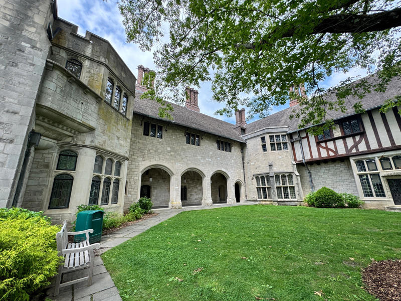 There are personalized touches all over the house's limestone exterior., It took three years to complete Coe Hall., One of the first rooms you can view is Coe's den., It's covered in dark wood, giving a masculine atmosphere., The art in the living room is original to the home., It's certainly not a bad place to spend your weekends., The craftsmanship throughout the house was impossible to miss., There was another portrait of Coe hanging in the corner., The main staircase felt straight out of a castle., And no, that's not wallpaper. This design was hand-painted onto the wall., The windows gave her a view of the gardens she painstakingly designed., This is her bathroom. Once again, it's very French., Now it was time to check out the much-revered grounds., Right off the bat, this fountain caught my eye., Can't you just hear someone saying, "Once upon a time…"?, Rogers entertained her friends in the Tea House on nice days., It looks like the inside of a Tiffany's box., Walking through it felt like walking through a storybook., One corner of the building was anchored by this giant palm tree., It has the largest collection of camellias under glass in the northeast., However, camellia season is in January, so we missed it.