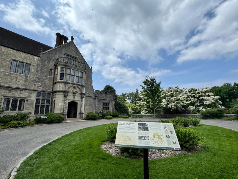 There are personalized touches all over the house's limestone exterior., It took three years to complete Coe Hall., One of the first rooms you can view is Coe's den., It's covered in dark wood, giving a masculine atmosphere., The art in the living room is original to the home., It's certainly not a bad place to spend your weekends., The craftsmanship throughout the house was impossible to miss., There was another portrait of Coe hanging in the corner., The main staircase felt straight out of a castle., And no, that's not wallpaper. This design was hand-painted onto the wall., The windows gave her a view of the gardens she painstakingly designed., This is her bathroom. Once again, it's very French., Now it was time to check out the much-revered grounds., Right off the bat, this fountain caught my eye., Can't you just hear someone saying, "Once upon a time…"?, Rogers entertained her friends in the Tea House on nice days., It looks like the inside of a Tiffany's box., Walking through it felt like walking through a storybook., One corner of the building was anchored by this giant palm tree., It has the largest collection of camellias under glass in the northeast., However, camellia season is in January, so we missed it.