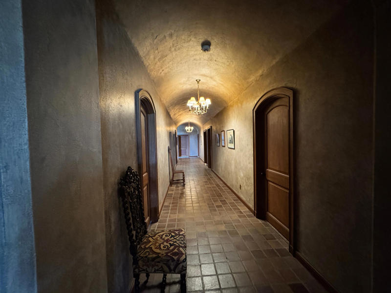 There are personalized touches all over the house's limestone exterior., It took three years to complete Coe Hall., One of the first rooms you can view is Coe's den., It's covered in dark wood, giving a masculine atmosphere., The art in the living room is original to the home., It's certainly not a bad place to spend your weekends., The craftsmanship throughout the house was impossible to miss., There was another portrait of Coe hanging in the corner., The main staircase felt straight out of a castle., And no, that's not wallpaper. This design was hand-painted onto the wall., The windows gave her a view of the gardens she painstakingly designed., This is her bathroom. Once again, it's very French., Now it was time to check out the much-revered grounds., Right off the bat, this fountain caught my eye., Can't you just hear someone saying, "Once upon a time…"?, Rogers entertained her friends in the Tea House on nice days., It looks like the inside of a Tiffany's box., Walking through it felt like walking through a storybook., One corner of the building was anchored by this giant palm tree., It has the largest collection of camellias under glass in the northeast., However, camellia season is in January, so we missed it.