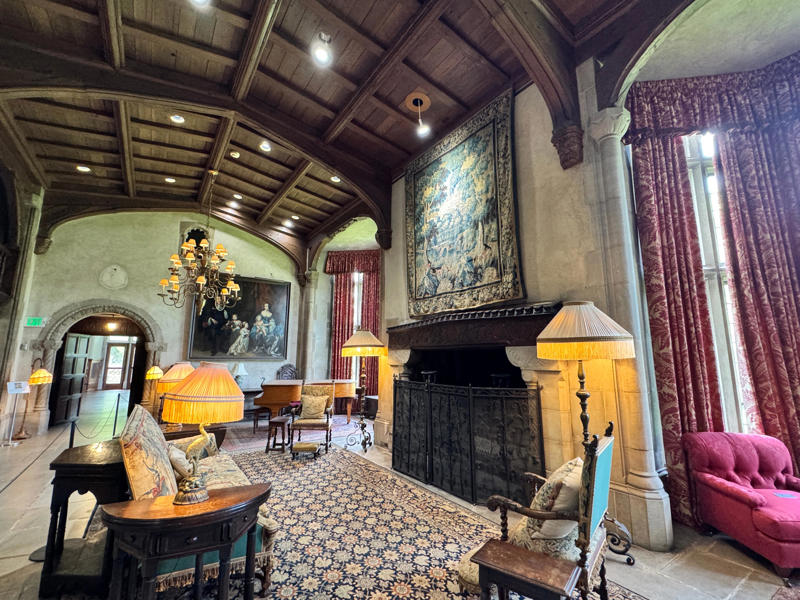 There are personalized touches all over the house's limestone exterior., It took three years to complete Coe Hall., One of the first rooms you can view is Coe's den., It's covered in dark wood, giving a masculine atmosphere., The art in the living room is original to the home., It's certainly not a bad place to spend your weekends., The craftsmanship throughout the house was impossible to miss., There was another portrait of Coe hanging in the corner., The main staircase felt straight out of a castle., And no, that's not wallpaper. This design was hand-painted onto the wall., The windows gave her a view of the gardens she painstakingly designed., This is her bathroom. Once again, it's very French., Now it was time to check out the much-revered grounds., Right off the bat, this fountain caught my eye., Can't you just hear someone saying, "Once upon a time…"?, Rogers entertained her friends in the Tea House on nice days., It looks like the inside of a Tiffany's box., Walking through it felt like walking through a storybook., One corner of the building was anchored by this giant palm tree., It has the largest collection of camellias under glass in the northeast., However, camellia season is in January, so we missed it.