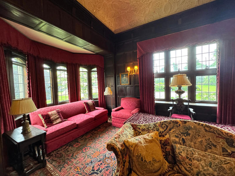 There are personalized touches all over the house's limestone exterior., It took three years to complete Coe Hall., One of the first rooms you can view is Coe's den., It's covered in dark wood, giving a masculine atmosphere., The art in the living room is original to the home., It's certainly not a bad place to spend your weekends., The craftsmanship throughout the house was impossible to miss., There was another portrait of Coe hanging in the corner., The main staircase felt straight out of a castle., And no, that's not wallpaper. This design was hand-painted onto the wall., The windows gave her a view of the gardens she painstakingly designed., This is her bathroom. Once again, it's very French., Now it was time to check out the much-revered grounds., Right off the bat, this fountain caught my eye., Can't you just hear someone saying, "Once upon a time…"?, Rogers entertained her friends in the Tea House on nice days., It looks like the inside of a Tiffany's box., Walking through it felt like walking through a storybook., One corner of the building was anchored by this giant palm tree., It has the largest collection of camellias under glass in the northeast., However, camellia season is in January, so we missed it.