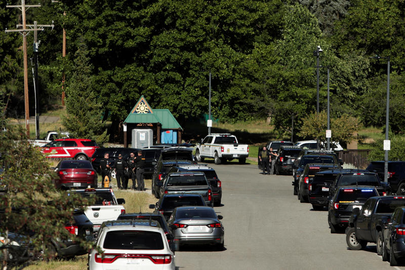Law enforcement officers gather at Cherry Hill Park after multiple firefighters were attacked when responding to a fire in the Canfield Mountain area outside Coeur dÕAlene, Idaho on June 29, 2025.