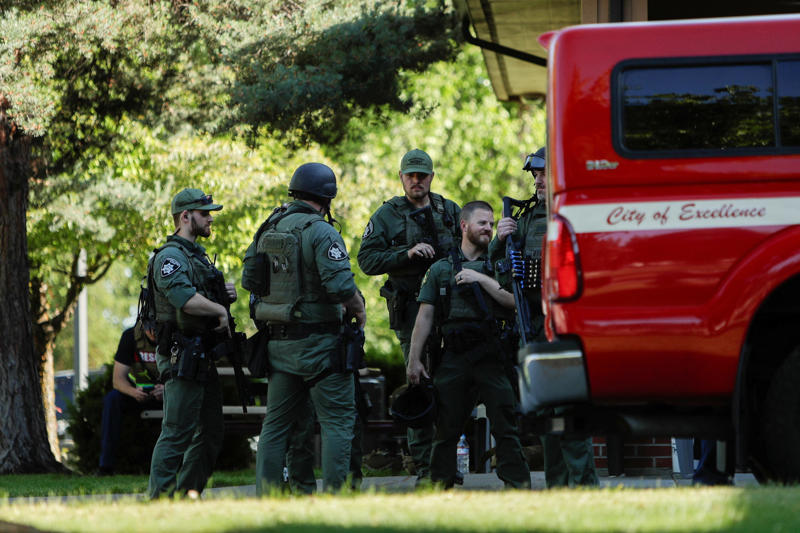 Law enforcement officers gather at Cherry Hill Park after multiple firefighters were attacked when responding to a fire in the Canfield Mountain area outside Coeur dÕAlene, Idaho on June 29, 2025.