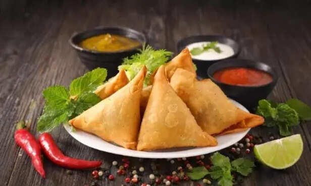 1. Samosa: The Persian Traveler, 2. Naan: Born in the Imperial Ovens, 3. Vindaloo: A Portuguese Party, 4. Chicken Tikka Masala: Born in Britain, 5. Biryani: Tracing Back to Persia, 6. Mulligatawny Soup: A Colonial Invention, 7. Chai: China’s Gift, India’s Obsession, 8. Gulab Jamun: A Persian Sweet Treat, 9. Falooda: From Iran With Love, 10. Jalebi: A Middle Eastern Spiral