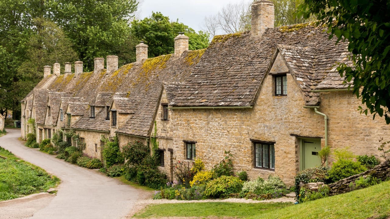 4. Bibury, England Set beside the Coln and stitched into the hills, Bibury whispers of England before speed. Honey-coloured cottages in tight rows, trout streams that glisten without reason, and hedgerows that seem older than maps. (Image: Canva) 1. Hallstatt, Austria Balanced between lake and limestone, Hallstatt reads like a forgotten chapter from an alpine fable. Its salt-stained history, mirrored waters, and slate-roofed homes draw quiet reverence, not crowds. In winter, it feels paused; in summer, painted. (Image: Canva), 2. Shirakawa-go, Japan Cradled by mountains and wrapped in thatch, Shirakawa-go holds firm to tradition. Its steep-roofed farmhouses, designed to endure snow and time, glow amber at dusk. The seasons arrive like guests—welcomed, noticed, remembered. (Image: Canva), 3. Colmar, France Colmar does not ask for attention—it commands it. With its riot of half-timbered homes, canal reflections, and Alsatian flourishes, it walks the line between theatre and truth. Even its shadows are deliberate. (Image: Canva), 4. Bibury, England Set beside the Coln and stitched into the hills, Bibury whispers of England before speed. Honey-coloured cottages in tight rows, trout streams that glisten without reason, and hedgerows that seem older than maps. (Image: Canva), 5. Giethoorn, Netherlands There are no cars in Giethoorn. Only boats, bridges, and hushed conversations. It is a village that floats, slowly, in its own rhythm. The canals speak softly; the thatched roofs never hurry. (Image: Canva), 6. Reine, Norway Beyond the Arctic Circle lies Reine—a scattering of crimson cabins that appear borrowed from a painting. Mountains rise like frozen waves behind them, and the sea never stops watching. Reine is remote, but never empty. (Image: Canva), 7. Eze, France High above the Riviera, where the cliffs fall into blue, sits Eze—a village of stone and shadow. Its alleys twist upward as if climbing toward memory. Time lingers here, in the scent of thyme and sea. (Image: Canva), 8. Goreme, Turkey Caves carved by wind and wonder—Goreme belongs to the Earth, not to man. Fairy chimneys pierce the sky, and hot-air balloons rise like thoughts at dawn. It is a village of both ground and sky. (Image: Canva), 9. Dinant, Belgium Hemmed in by cliff and river, Dinant feels composed rather than built. Saxophones hang from bridges, limestone watches from above, and the Meuse flows through it like a quiet refrain. Gothic never looked so lyrical. (Image: Canva), 10. Leavenworth, Washington, USA This village is not a replica—it’s a reinvention. Bavarian beams beneath American skies, brats beside apple pie. Surrounded by pine, performance, and peaks, Leavenworth is both celebration and curiosity, wrapped in wood and wonder. (Image: Canva)