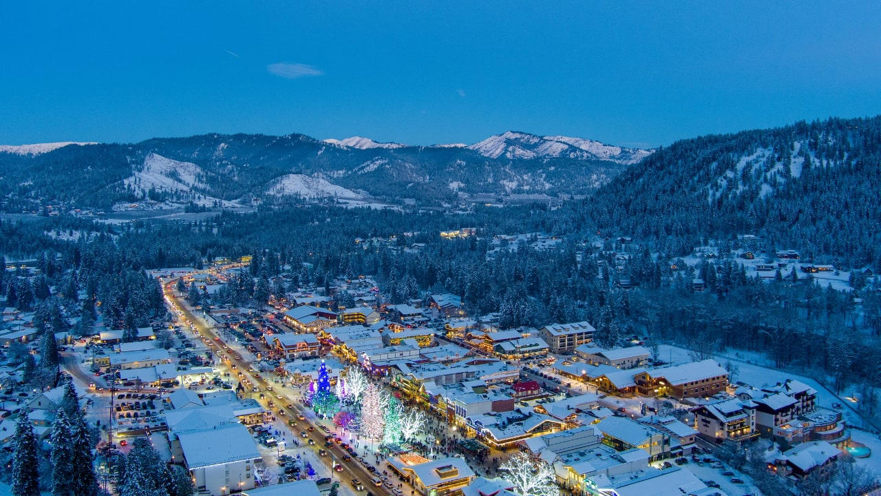 10. Leavenworth, Washington, USA This village is not a replica—it’s a reinvention. Bavarian beams beneath American skies, brats beside apple pie. Surrounded by pine, performance, and peaks, Leavenworth is both celebration and curiosity, wrapped in wood and wonder. (Image: Canva) 1. Hallstatt, Austria Balanced between lake and limestone, Hallstatt reads like a forgotten chapter from an alpine fable. Its salt-stained history, mirrored waters, and slate-roofed homes draw quiet reverence, not crowds. In winter, it feels paused; in summer, painted. (Image: Canva), 2. Shirakawa-go, Japan Cradled by mountains and wrapped in thatch, Shirakawa-go holds firm to tradition. Its steep-roofed farmhouses, designed to endure snow and time, glow amber at dusk. The seasons arrive like guests—welcomed, noticed, remembered. (Image: Canva), 3. Colmar, France Colmar does not ask for attention—it commands it. With its riot of half-timbered homes, canal reflections, and Alsatian flourishes, it walks the line between theatre and truth. Even its shadows are deliberate. (Image: Canva), 4. Bibury, England Set beside the Coln and stitched into the hills, Bibury whispers of England before speed. Honey-coloured cottages in tight rows, trout streams that glisten without reason, and hedgerows that seem older than maps. (Image: Canva), 5. Giethoorn, Netherlands There are no cars in Giethoorn. Only boats, bridges, and hushed conversations. It is a village that floats, slowly, in its own rhythm. The canals speak softly; the thatched roofs never hurry. (Image: Canva), 6. Reine, Norway Beyond the Arctic Circle lies Reine—a scattering of crimson cabins that appear borrowed from a painting. Mountains rise like frozen waves behind them, and the sea never stops watching. Reine is remote, but never empty. (Image: Canva), 7. Eze, France High above the Riviera, where the cliffs fall into blue, sits Eze—a village of stone and shadow. Its alleys twist upward as if climbing toward memory. Time lingers here, in the scent of thyme and sea. (Image: Canva), 8. Goreme, Turkey Caves carved by wind and wonder—Goreme belongs to the Earth, not to man. Fairy chimneys pierce the sky, and hot-air balloons rise like thoughts at dawn. It is a village of both ground and sky. (Image: Canva), 9. Dinant, Belgium Hemmed in by cliff and river, Dinant feels composed rather than built. Saxophones hang from bridges, limestone watches from above, and the Meuse flows through it like a quiet refrain. Gothic never looked so lyrical. (Image: Canva), 10. Leavenworth, Washington, USA This village is not a replica—it’s a reinvention. Bavarian beams beneath American skies, brats beside apple pie. Surrounded by pine, performance, and peaks, Leavenworth is both celebration and curiosity, wrapped in wood and wonder. (Image: Canva)