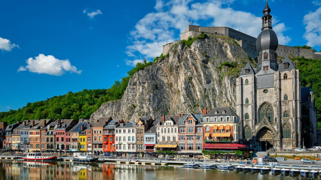9. Dinant, Belgium Hemmed in by cliff and river, Dinant feels composed rather than built. Saxophones hang from bridges, limestone watches from above, and the Meuse flows through it like a quiet refrain. Gothic never looked so lyrical. (Image: Canva) 1. Hallstatt, Austria Balanced between lake and limestone, Hallstatt reads like a forgotten chapter from an alpine fable. Its salt-stained history, mirrored waters, and slate-roofed homes draw quiet reverence, not crowds. In winter, it feels paused; in summer, painted. (Image: Canva), 2. Shirakawa-go, Japan Cradled by mountains and wrapped in thatch, Shirakawa-go holds firm to tradition. Its steep-roofed farmhouses, designed to endure snow and time, glow amber at dusk. The seasons arrive like guests—welcomed, noticed, remembered. (Image: Canva), 3. Colmar, France Colmar does not ask for attention—it commands it. With its riot of half-timbered homes, canal reflections, and Alsatian flourishes, it walks the line between theatre and truth. Even its shadows are deliberate. (Image: Canva), 4. Bibury, England Set beside the Coln and stitched into the hills, Bibury whispers of England before speed. Honey-coloured cottages in tight rows, trout streams that glisten without reason, and hedgerows that seem older than maps. (Image: Canva), 5. Giethoorn, Netherlands There are no cars in Giethoorn. Only boats, bridges, and hushed conversations. It is a village that floats, slowly, in its own rhythm. The canals speak softly; the thatched roofs never hurry. (Image: Canva), 6. Reine, Norway Beyond the Arctic Circle lies Reine—a scattering of crimson cabins that appear borrowed from a painting. Mountains rise like frozen waves behind them, and the sea never stops watching. Reine is remote, but never empty. (Image: Canva), 7. Eze, France High above the Riviera, where the cliffs fall into blue, sits Eze—a village of stone and shadow. Its alleys twist upward as if climbing toward memory. Time lingers here, in the scent of thyme and sea. (Image: Canva), 8. Goreme, Turkey Caves carved by wind and wonder—Goreme belongs to the Earth, not to man. Fairy chimneys pierce the sky, and hot-air balloons rise like thoughts at dawn. It is a village of both ground and sky. (Image: Canva), 9. Dinant, Belgium Hemmed in by cliff and river, Dinant feels composed rather than built. Saxophones hang from bridges, limestone watches from above, and the Meuse flows through it like a quiet refrain. Gothic never looked so lyrical. (Image: Canva), 10. Leavenworth, Washington, USA This village is not a replica—it’s a reinvention. Bavarian beams beneath American skies, brats beside apple pie. Surrounded by pine, performance, and peaks, Leavenworth is both celebration and curiosity, wrapped in wood and wonder. (Image: Canva)