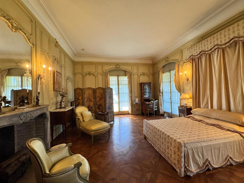 William II had two wives — this is how the bedroom looked when it was occupied by his second wife, Rosamond Lancaster Warburton. Inside the grounds are hiking trails, gardens, and a gift shop., Before I toured the home, I visited the museum grounds., But the landscaping was still immaculate., Then it was time to head over to Eagle's Nest., One side of the mansion is a natural history museum., The first room I saw was the dining room., The ceiling is constructed from Florida cedar, or Southern Red cedar., This is her changing room and bathroom., The house was set on a hill, so the yard was multi-level., First, I walked to the right., There was a large reflecting pool., But the main attraction was, once again, the view., To my surprise, it was a filled-in saltwater pool., They'd even left the ladder in., There were also changing rooms.
