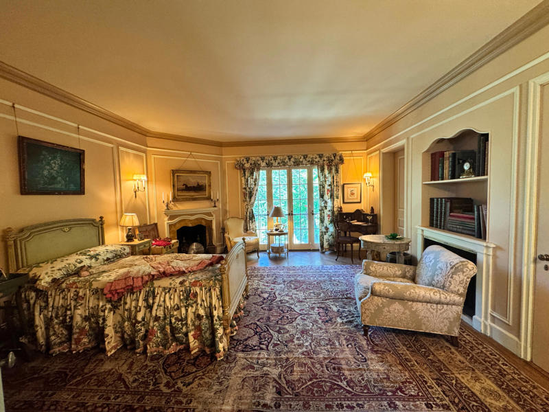 Here's one of the guest rooms open for display. Each guest room had its own closet and bathroom. Inside the grounds are hiking trails, gardens, and a gift shop., Before I toured the home, I visited the museum grounds., But the landscaping was still immaculate., Then it was time to head over to Eagle's Nest., One side of the mansion is a natural history museum., The first room I saw was the dining room., The ceiling is constructed from Florida cedar, or Southern Red cedar., This is her changing room and bathroom., The house was set on a hill, so the yard was multi-level., First, I walked to the right., There was a large reflecting pool., But the main attraction was, once again, the view., To my surprise, it was a filled-in saltwater pool., They'd even left the ladder in., There were also changing rooms.
