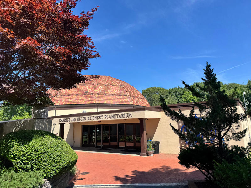 There's also the Charles and Helen Reichert Planetarium, which holds multiple shows daily. Inside the grounds are hiking trails, gardens, and a gift shop., Before I toured the home, I visited the museum grounds., But the landscaping was still immaculate., Then it was time to head over to Eagle's Nest., One side of the mansion is a natural history museum., The first room I saw was the dining room., The ceiling is constructed from Florida cedar, or Southern Red cedar., This is her changing room and bathroom., The house was set on a hill, so the yard was multi-level., First, I walked to the right., There was a large reflecting pool., But the main attraction was, once again, the view., To my surprise, it was a filled-in saltwater pool., They'd even left the ladder in., There were also changing rooms.