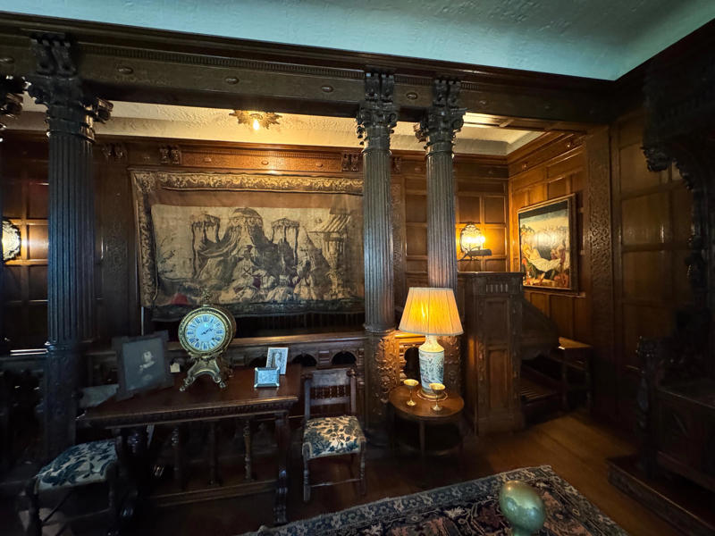 One upstairs sitting room was almost entirely covered in dark wood. It also housed a giant organ. Inside the grounds are hiking trails, gardens, and a gift shop., Before I toured the home, I visited the museum grounds., But the landscaping was still immaculate., Then it was time to head over to Eagle's Nest., One side of the mansion is a natural history museum., The first room I saw was the dining room., The ceiling is constructed from Florida cedar, or Southern Red cedar., This is her changing room and bathroom., The house was set on a hill, so the yard was multi-level., First, I walked to the right., There was a large reflecting pool., But the main attraction was, once again, the view., To my surprise, it was a filled-in saltwater pool., They'd even left the ladder in., There were also changing rooms.
