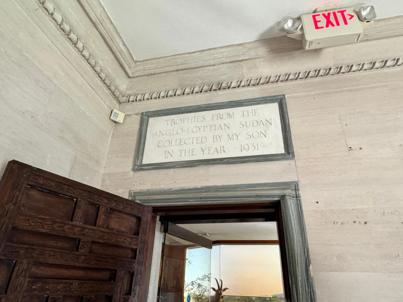 As I left the living quarters, I reached one of the entrances to the museum. This room is dedicated to William II's son, William K. Vanderbilt III. Inside the grounds are hiking trails, gardens, and a gift shop., Before I toured the home, I visited the museum grounds., But the landscaping was still immaculate., Then it was time to head over to Eagle's Nest., One side of the mansion is a natural history museum., The first room I saw was the dining room., The ceiling is constructed from Florida cedar, or Southern Red cedar., This is her changing room and bathroom., The house was set on a hill, so the yard was multi-level., First, I walked to the right., There was a large reflecting pool., But the main attraction was, once again, the view., To my surprise, it was a filled-in saltwater pool., They'd even left the ladder in., There were also changing rooms.