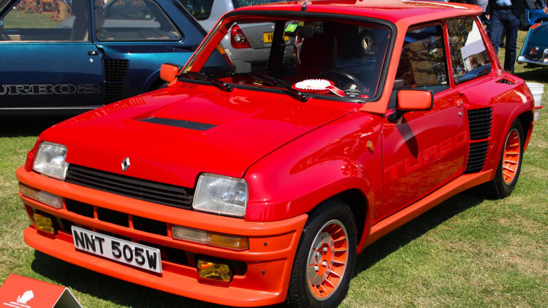 Cars That Carry A Flag, Lamborghini Miura, The Answer, Toyota 2000GT, Volkswagen Beetle, Ford GT40, Citroen DS, Datsun 240Z, Rolls-Royce Phantom, Renault 5 Turbo, Chevrolet Corvette C1, Koenigsegg Jesko, Fiat 500 (Cinquecento), Aston Martin DB5, Hyundai Pony, Tatra 87, Mazda MX-5 Miata NA, BMW M3 E30, Volvo P1800, Peugeot 205 GTI, Pontiac Firebird Trans Am, Pagani Zonda, SAAB 900 Turbo, Porsche 911 (1964)