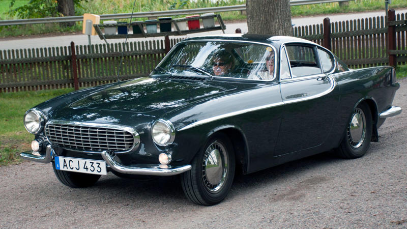 Cars That Carry A Flag, Lamborghini Miura, The Answer, Toyota 2000GT, Volkswagen Beetle, Ford GT40, Citroen DS, Datsun 240Z, Rolls-Royce Phantom, Renault 5 Turbo, Chevrolet Corvette C1, Koenigsegg Jesko, Fiat 500 (Cinquecento), Aston Martin DB5, Hyundai Pony, Tatra 87, Mazda MX-5 Miata NA, BMW M3 E30, Volvo P1800, Peugeot 205 GTI, Pontiac Firebird Trans Am, Pagani Zonda, SAAB 900 Turbo, Porsche 911 (1964)
