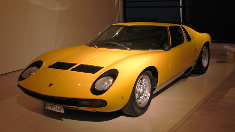 Cars That Carry A Flag, Lamborghini Miura, The Answer, Toyota 2000GT, Volkswagen Beetle, Ford GT40, Citroen DS, Datsun 240Z, Rolls-Royce Phantom, Renault 5 Turbo, Chevrolet Corvette C1, Koenigsegg Jesko, Fiat 500 (Cinquecento), Aston Martin DB5, Hyundai Pony, Tatra 87, Mazda MX-5 Miata NA, BMW M3 E30, Volvo P1800, Peugeot 205 GTI, Pontiac Firebird Trans Am, Pagani Zonda, SAAB 900 Turbo, Porsche 911 (1964)