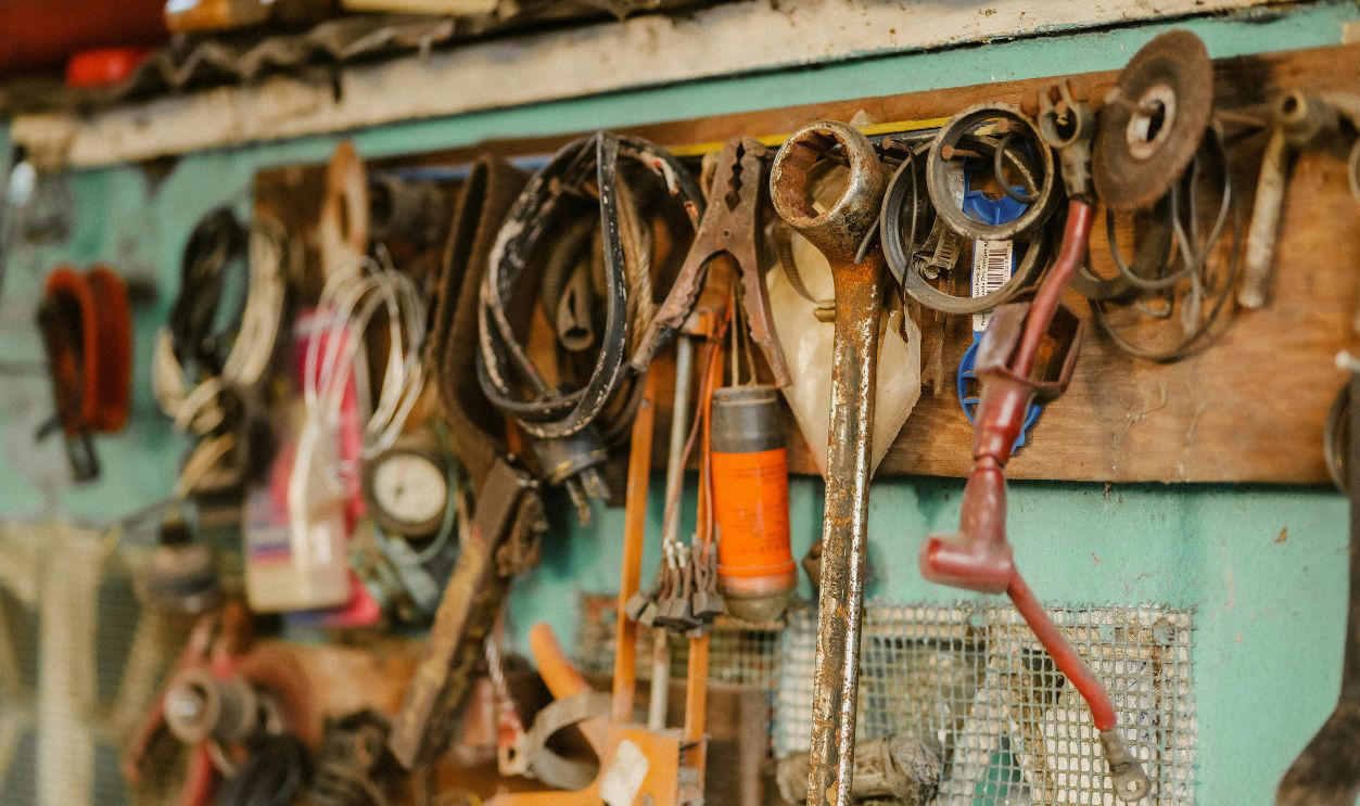 Boomer Garages Feel Like Time Capsules, Coffee Cans Full Of Screws, Old License Plates, WD-40 Spray Cans, Fishing Rods From The 1970s, Pegboard Tool Walls, Paint Cans With Dried Lids, Jumper Cables In A Knot, Glass Jars Of Bolts, Garden Gloves With Cracked Palms, National Geographic Stacks, Manual Jack And Tire Iron, Portable Work Lights, Push Reel Lawn Mower, Garage Fridge, Manual Grass Clippers, Workbench With A Vise-Grip, Christmas Lights In Grocery Bags, Spare Fan Belts, Wood Cabinets With Mystery Drawers, Old Radios, Plastic Buckets Of Hardware, Car Wax Kits, Tangled Extension Cords, Sears Folding Workbench, Mason Jars Of Random Parts