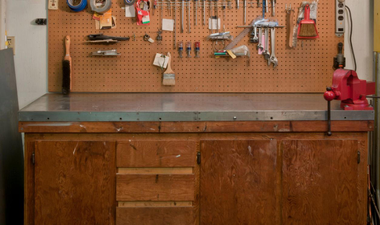 Boomer Garages Feel Like Time Capsules, Coffee Cans Full Of Screws, Old License Plates, WD-40 Spray Cans, Fishing Rods From The 1970s, Pegboard Tool Walls, Paint Cans With Dried Lids, Jumper Cables In A Knot, Glass Jars Of Bolts, Garden Gloves With Cracked Palms, National Geographic Stacks, Manual Jack And Tire Iron, Portable Work Lights, Push Reel Lawn Mower, Garage Fridge, Manual Grass Clippers, Workbench With A Vise-Grip, Christmas Lights In Grocery Bags, Spare Fan Belts, Wood Cabinets With Mystery Drawers, Old Radios, Plastic Buckets Of Hardware, Car Wax Kits, Tangled Extension Cords, Sears Folding Workbench, Mason Jars Of Random Parts