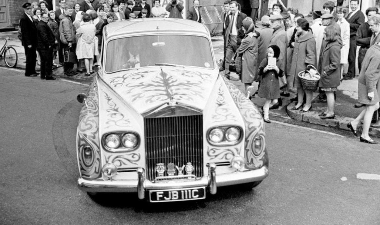 Decades Later, It’s Still A Symbol Of Creative Defiance A Rock Star At His Peak And The Car That Reflected It, Why John Chose A Rolls-Royce, Not A Sporty Jaguar, Polished Black And Perfectly Conventional At First, Something Was Missing, The Psychedelic Era Was Exploding, And So Was His Imagination, From Limousine To Canvas: The Idea To Transform It, Inspired By Gypsies, Daydreams, And Eastern Designs, The Painters Behind The Paint Job, What Those Swirls And Motifs Really Meant, Londoners Were Shocked, And Some Were Furious, Art, Rebellion, Or Just Eccentricity?, Snobbery In Overdrive, The Beatles Were Changing, And So Were Their Cars, Lennon’s Rolls Becomes A Rolling Manifesto For Change, It Wasn’t Just A Showpiece, Was It Ever In The Film?, It Was Lennon’s Mobile Stage, Why He Let It Go And The Quiet Goodbye, A Gift To Canada, Its New Home, Faded Paint And Fresh Restorations Over The Years, Decades Later, It’s Still A Symbol Of Creative Defiance, Colorful Legacy