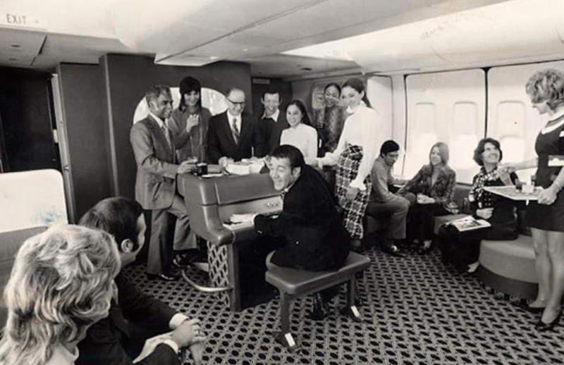“The piano bar in the back of an American Airlines flight in the 70s.” “My dad, probably 1970s. This is my favourite photo of him.”, “Pacific Southwest Airlines Stewardesses from the 70’s.”, “Economy class flying in 1970.”, “70’s Vintage Airline Stewardess.”, “Iran Air flight attendants in the 1970s.”, “First class on a United flight, 1970.”, An American Airlines advertisement from 1971., “Led Zeppelin (Early 1970s).”, “Chilling and smoking mid-air in the 70s.”, “Southwest Airlines Flight Attendant, Late 70s.”, “Elvis Presley & Linda Thompson boarding a plane mid 70’s.”, “My flight attendant mom getting some oxygen for her hangover (70s).”, “Economy seating on Pan Am in the 70s.”, “These Vintage Photos of flight Stewardesses 70’s.”
