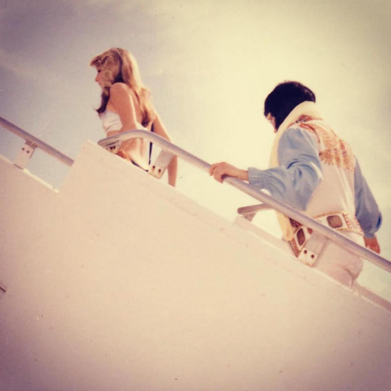 “Elvis Presley & Linda Thompson boarding a plane mid 70’s.” “My dad, probably 1970s. This is my favourite photo of him.”, “Pacific Southwest Airlines Stewardesses from the 70’s.”, “Economy class flying in 1970.”, “70’s Vintage Airline Stewardess.”, “Iran Air flight attendants in the 1970s.”, “First class on a United flight, 1970.”, An American Airlines advertisement from 1971., “Led Zeppelin (Early 1970s).”, “Chilling and smoking mid-air in the 70s.”, “Southwest Airlines Flight Attendant, Late 70s.”, “Elvis Presley & Linda Thompson boarding a plane mid 70’s.”, “My flight attendant mom getting some oxygen for her hangover (70s).”, “Economy seating on Pan Am in the 70s.”, “These Vintage Photos of flight Stewardesses 70’s.”