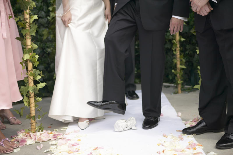 Stepping on a glass Some wedding traditions aren’t as 'innocent' as you think, The bridal veil, Exchanging rings, Carrying the bride over the threshold, The wedding cake, The bride’s garter, Stepping on a glass, Bride kidnapping
