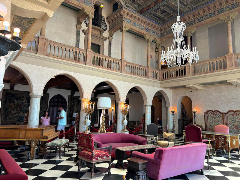 The central court, which houses a grand piano and custom ceiling panels, was the heart of the mansion. Colored glass windows bring Sarasota's Gulf Coast into the mansion., The ballroom and its ornate ceiling are standout features of the property., The ballroom ceiling is comprised of 22 custom canvases., The formal dining room features design inspirations from all over the Mediterranean., Often, guests arrived by sea., Visitors to Ca' d'Zan can also enjoy the Ringlings' circus museum., The Ringlings' legacy continues to dazzle visitors.