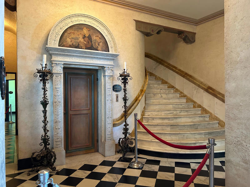 In another display of early 20th-century technology, the mansion has a private elevator. Colored glass windows bring Sarasota's Gulf Coast into the mansion., The ballroom and its ornate ceiling are standout features of the property., The ballroom ceiling is comprised of 22 custom canvases., The formal dining room features design inspirations from all over the Mediterranean., Often, guests arrived by sea., Visitors to Ca' d'Zan can also enjoy the Ringlings' circus museum., The Ringlings' legacy continues to dazzle visitors.