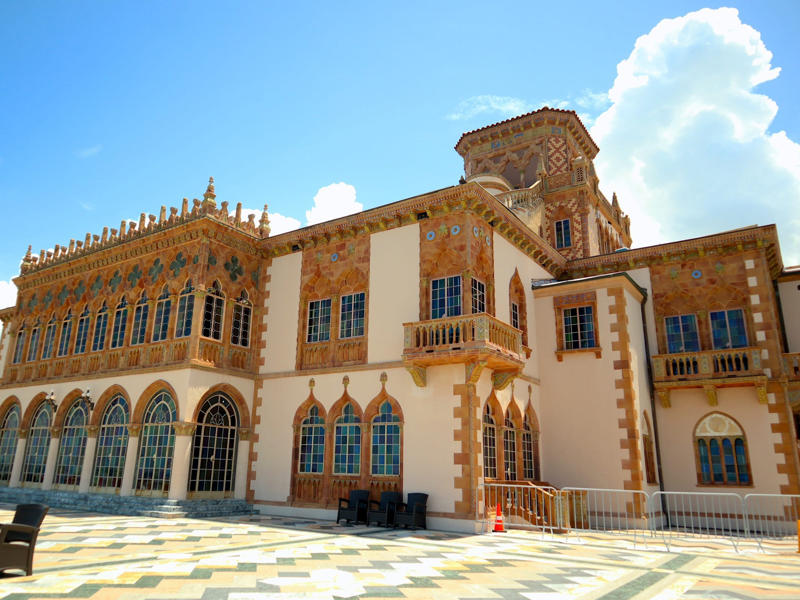 Often, guests arrived by sea. Colored glass windows bring Sarasota's Gulf Coast into the mansion., The ballroom and its ornate ceiling are standout features of the property., The ballroom ceiling is comprised of 22 custom canvases., The formal dining room features design inspirations from all over the Mediterranean., Often, guests arrived by sea., Visitors to Ca' d'Zan can also enjoy the Ringlings' circus museum., The Ringlings' legacy continues to dazzle visitors.