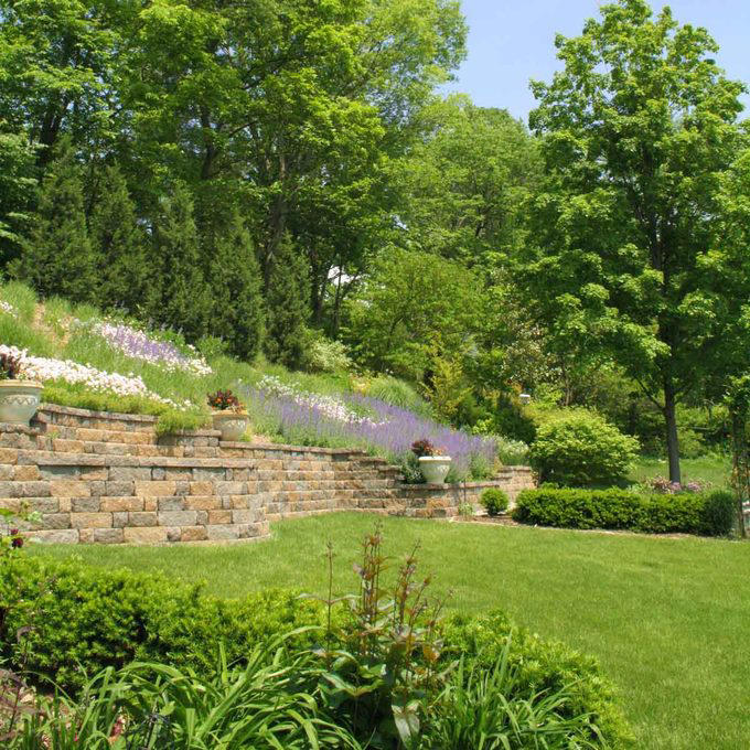 Terraced Hillside Landscaping, Steps with Retaining Wall, Create a Rock Garden, Hillside Water Feature, Front Yard Retaining Wall, Patio Overlook, Hillside Landscaping with Mulch, Tiered Raised Beds, Front Deck for a Sloped Yard, Prairie Garden Hillside Landscaping