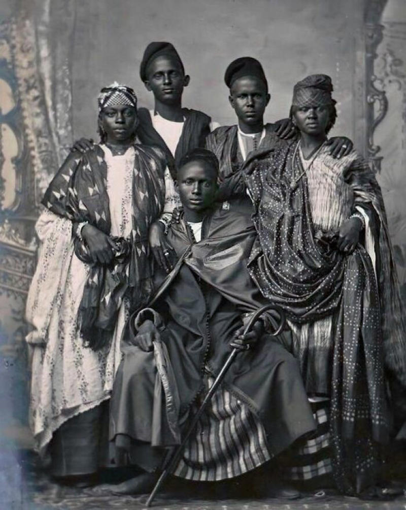 Wolof Family Portrait by Emile Noal Royal Dining with Angela Lansbury and Basil Rathbone, Breaking Barriers: Mary Wallace’s Historic Drive, Strength and Heritage in Canyon De Chelly, Portrait of Youth: Kiowa Girl, Berber Beauty: Ouled Nail Girl, A Shared Moment: Paula and Her Kitten, Marilyn Monroe’s Playful Potato Sack Look, Challenging the Rules: Brooklyn Dress Code Protest, 1940, Wolof Family Portrait by Emile Noal, Reunion After a Long Voyage, Elegance in Motion: Manon Chaufour by Martin Imboden, Dad’s Got Moves: Melbourne, 1940s, Fire Escape Embrace, 1946, Ani Chokyi of Tibet, Captured in Darjeeling, 1890s, Headlines and Daydreams, Champs Elysées, 1947, Timeless Athens: The Acropolis in 1860, Catharina ‘Toto’ Koopman: A Parisian Muse, 1933, On the Road Together: Family Hitchhiking, California, Einstein and His Beloved Violin, 1941, Edmund Kesting’s Play with Light and Shadow, 1930, Champagne Inspector in Protective Mask, Helen Bennett’s Stunning Spider Dress, 1939, Harriet Hoctor’s Graceful Question Mark, 1925, Double the Dazzle: The Dolly Sisters in the 1920s, Glamour at The Forbidden City, 1948, Double the Glamour: Mother-Daughter Style, 1954, Cardboard Couture: Sicilian Suit Substitute, The Day Daddy Came Home: Hector Murdoch’s Return, Courage Behind Bars: Mexico, 1935, Milk Time Mischief at Arch Badertscher’s Farm