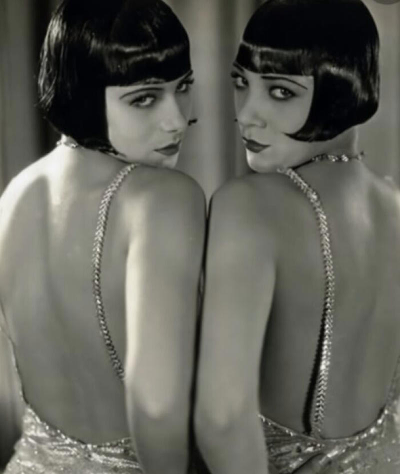 Double the Dazzle: The Dolly Sisters in the 1920s Royal Dining with Angela Lansbury and Basil Rathbone, Breaking Barriers: Mary Wallace’s Historic Drive, Strength and Heritage in Canyon De Chelly, Portrait of Youth: Kiowa Girl, Berber Beauty: Ouled Nail Girl, A Shared Moment: Paula and Her Kitten, Marilyn Monroe’s Playful Potato Sack Look, Challenging the Rules: Brooklyn Dress Code Protest, 1940, Wolof Family Portrait by Emile Noal, Reunion After a Long Voyage, Elegance in Motion: Manon Chaufour by Martin Imboden, Dad’s Got Moves: Melbourne, 1940s, Fire Escape Embrace, 1946, Ani Chokyi of Tibet, Captured in Darjeeling, 1890s, Headlines and Daydreams, Champs Elysées, 1947, Timeless Athens: The Acropolis in 1860, Catharina ‘Toto’ Koopman: A Parisian Muse, 1933, On the Road Together: Family Hitchhiking, California, Einstein and His Beloved Violin, 1941, Edmund Kesting’s Play with Light and Shadow, 1930, Champagne Inspector in Protective Mask, Helen Bennett’s Stunning Spider Dress, 1939, Harriet Hoctor’s Graceful Question Mark, 1925, Double the Dazzle: The Dolly Sisters in the 1920s, Glamour at The Forbidden City, 1948, Double the Glamour: Mother-Daughter Style, 1954, Cardboard Couture: Sicilian Suit Substitute, The Day Daddy Came Home: Hector Murdoch’s Return, Courage Behind Bars: Mexico, 1935, Milk Time Mischief at Arch Badertscher’s Farm