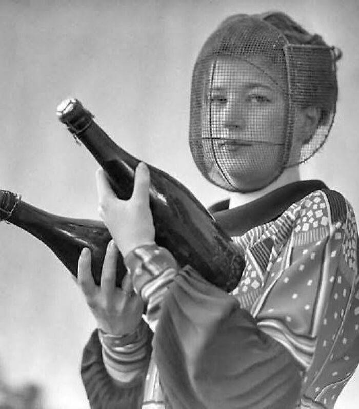 Champagne Inspector in Protective Mask Royal Dining with Angela Lansbury and Basil Rathbone, Breaking Barriers: Mary Wallace’s Historic Drive, Strength and Heritage in Canyon De Chelly, Portrait of Youth: Kiowa Girl, Berber Beauty: Ouled Nail Girl, A Shared Moment: Paula and Her Kitten, Marilyn Monroe’s Playful Potato Sack Look, Challenging the Rules: Brooklyn Dress Code Protest, 1940, Wolof Family Portrait by Emile Noal, Reunion After a Long Voyage, Elegance in Motion: Manon Chaufour by Martin Imboden, Dad’s Got Moves: Melbourne, 1940s, Fire Escape Embrace, 1946, Ani Chokyi of Tibet, Captured in Darjeeling, 1890s, Headlines and Daydreams, Champs Elysées, 1947, Timeless Athens: The Acropolis in 1860, Catharina ‘Toto’ Koopman: A Parisian Muse, 1933, On the Road Together: Family Hitchhiking, California, Einstein and His Beloved Violin, 1941, Edmund Kesting’s Play with Light and Shadow, 1930, Champagne Inspector in Protective Mask, Helen Bennett’s Stunning Spider Dress, 1939, Harriet Hoctor’s Graceful Question Mark, 1925, Double the Dazzle: The Dolly Sisters in the 1920s, Glamour at The Forbidden City, 1948, Double the Glamour: Mother-Daughter Style, 1954, Cardboard Couture: Sicilian Suit Substitute, The Day Daddy Came Home: Hector Murdoch’s Return, Courage Behind Bars: Mexico, 1935, Milk Time Mischief at Arch Badertscher’s Farm