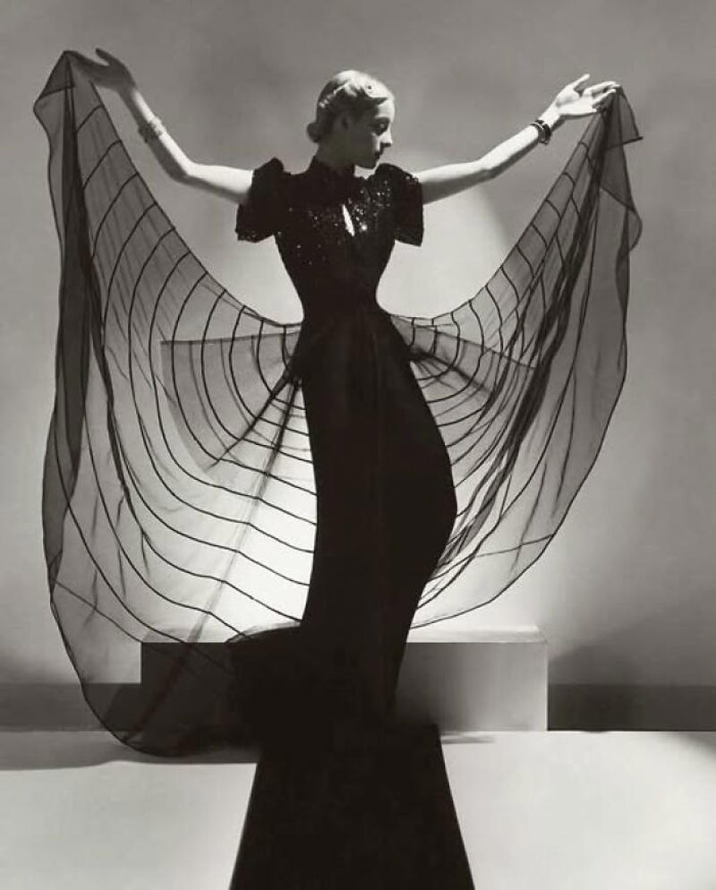 Helen Bennett’s Stunning Spider Dress, 1939 Royal Dining with Angela Lansbury and Basil Rathbone, Breaking Barriers: Mary Wallace’s Historic Drive, Strength and Heritage in Canyon De Chelly, Portrait of Youth: Kiowa Girl, Berber Beauty: Ouled Nail Girl, A Shared Moment: Paula and Her Kitten, Marilyn Monroe’s Playful Potato Sack Look, Challenging the Rules: Brooklyn Dress Code Protest, 1940, Wolof Family Portrait by Emile Noal, Reunion After a Long Voyage, Elegance in Motion: Manon Chaufour by Martin Imboden, Dad’s Got Moves: Melbourne, 1940s, Fire Escape Embrace, 1946, Ani Chokyi of Tibet, Captured in Darjeeling, 1890s, Headlines and Daydreams, Champs Elysées, 1947, Timeless Athens: The Acropolis in 1860, Catharina ‘Toto’ Koopman: A Parisian Muse, 1933, On the Road Together: Family Hitchhiking, California, Einstein and His Beloved Violin, 1941, Edmund Kesting’s Play with Light and Shadow, 1930, Champagne Inspector in Protective Mask, Helen Bennett’s Stunning Spider Dress, 1939, Harriet Hoctor’s Graceful Question Mark, 1925, Double the Dazzle: The Dolly Sisters in the 1920s, Glamour at The Forbidden City, 1948, Double the Glamour: Mother-Daughter Style, 1954, Cardboard Couture: Sicilian Suit Substitute, The Day Daddy Came Home: Hector Murdoch’s Return, Courage Behind Bars: Mexico, 1935, Milk Time Mischief at Arch Badertscher’s Farm