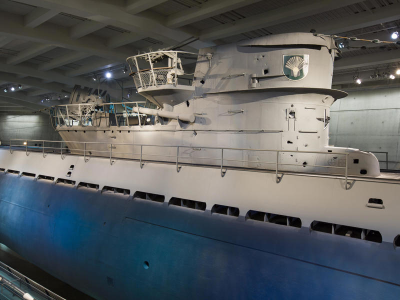 Atop the submarine sits the conning tower, used for navigation, protection, and observation. Bullet holes can be seen all over the conning tower., The first stop on my tour was the petty officer's quarters., When the U-505 was on patrol, it carried 12 tons of food., The crew had to navigate various challenges while underwater, including high temperatures., All calculations before firing a torpedo were done with pen and paper., The US Navy captured the U-505 on June 4, 1944., To prevent the U-505's capture, the Germans tried one last trick., On September 2, 1954, the submarine was hauled across Lake Shore Drive in Chicago., At first, the submarine was displayed outside the museum.