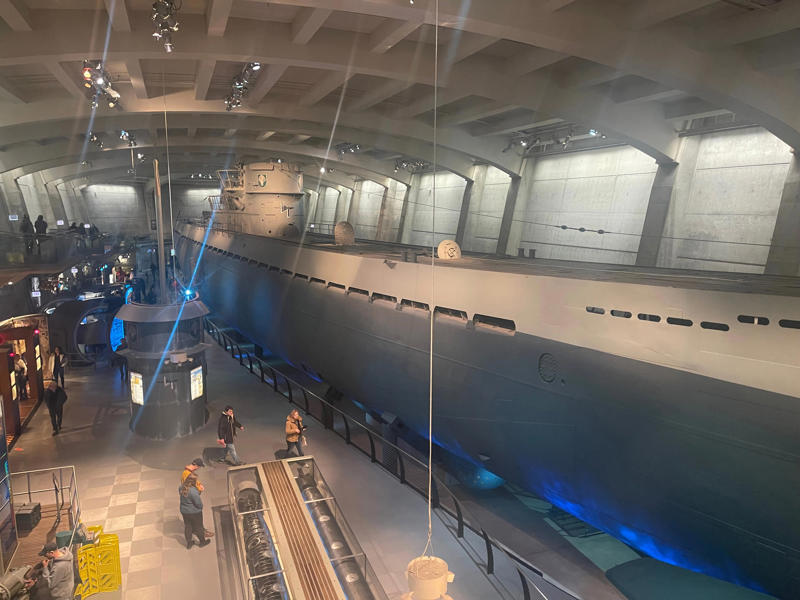 Exiting the U-505 exhibit, I was amazed by the life crewmembers had lived on board. Bullet holes can be seen all over the conning tower., The first stop on my tour was the petty officer's quarters., When the U-505 was on patrol, it carried 12 tons of food., The crew had to navigate various challenges while underwater, including high temperatures., All calculations before firing a torpedo were done with pen and paper., The US Navy captured the U-505 on June 4, 1944., To prevent the U-505's capture, the Germans tried one last trick., On September 2, 1954, the submarine was hauled across Lake Shore Drive in Chicago., At first, the submarine was displayed outside the museum.