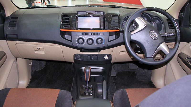 Whichever Way You Go, There’s A Trade-Off, Its Entry Price Under K Is A Budget Standout, It Comes With Three Engine Options For Every Type Of Driver, The Champ Was Built On Toyota’s Proven IMV Platform, The Bolt-On Body System Enables DIY Configurations, The Champ Is Offered In Two Wheelbase Lengths, It Gets To Work With A 1-Ton Payload, Toyota Gazoo Racing Built A Track Version, Champs’s Optional Diesel Engine Gets Automatic Transmission, The Camper Versions Feature Solar And Hot Water, The Truck Has A Short Turning Radius, The Champ’s Fuel Economy Beats Most US Trucks, The Champ Has Manual Crank Windows And No Infotainment, The Truck Has Basic Safety Features, The Interior Is Designed For Utility, Not Luxury, No US Release Due To Safety And Emissions, Its Flat Deck Comes Standard On The Entry Model, This Model's AC Is Optional, Not Standard, The Trucks’s Custom Add-Ons Often Fall Outside Toyota Support, All Champ Models Use Steel Wheels, It Has Limited Theft Protection Features, The Champ’s Leaf-Spring Suspension Limits Comfort, The Paint And Trim Options Are Minimal