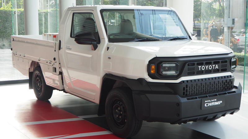 Whichever Way You Go, There’s A Trade-Off, Its Entry Price Under K Is A Budget Standout, It Comes With Three Engine Options For Every Type Of Driver, The Champ Was Built On Toyota’s Proven IMV Platform, The Bolt-On Body System Enables DIY Configurations, The Champ Is Offered In Two Wheelbase Lengths, It Gets To Work With A 1-Ton Payload, Toyota Gazoo Racing Built A Track Version, Champs’s Optional Diesel Engine Gets Automatic Transmission, The Camper Versions Feature Solar And Hot Water, The Truck Has A Short Turning Radius, The Champ’s Fuel Economy Beats Most US Trucks, The Champ Has Manual Crank Windows And No Infotainment, The Truck Has Basic Safety Features, The Interior Is Designed For Utility, Not Luxury, No US Release Due To Safety And Emissions, Its Flat Deck Comes Standard On The Entry Model, This Model's AC Is Optional, Not Standard, The Trucks’s Custom Add-Ons Often Fall Outside Toyota Support, All Champ Models Use Steel Wheels, It Has Limited Theft Protection Features, The Champ’s Leaf-Spring Suspension Limits Comfort, The Paint And Trim Options Are Minimal