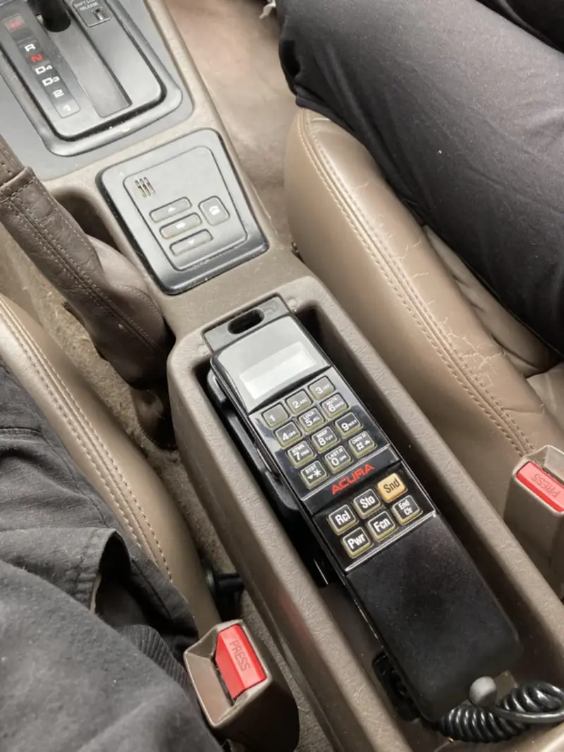 1. Automatic Seat Belts, 2. Car Phones, 3. Pop-Up Headlights, 4. Cigarette Lighters and Ashtrays, 5. Bench Front Seats, 6. Manual Window Cranks, 7. Tape Decks and CD Players, 8. Hood Ornaments, 9. Hidden Gas Caps Behind License Plates