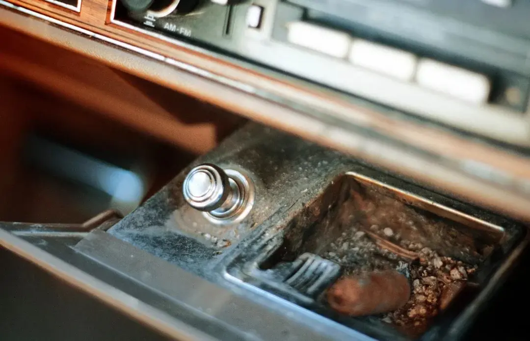 1. Automatic Seat Belts, 2. Car Phones, 3. Pop-Up Headlights, 4. Cigarette Lighters and Ashtrays, 5. Bench Front Seats, 6. Manual Window Cranks, 7. Tape Decks and CD Players, 8. Hood Ornaments, 9. Hidden Gas Caps Behind License Plates