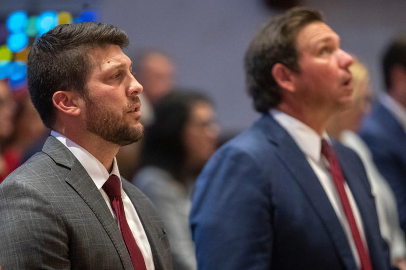 James Uthmeier sworn in as Florida Attorney General, Deputy Alex Mercado honored for public service award, Migrants waiting for U.S. Border Patrol processing, Gov. Ron DeSantis at Red Mass with James Uthmeier, Migrants transported for processing by Border Patrol, Kirsten Bridegan receives Back the Blue Award, James Uthmeier sworn in surrounded by family
