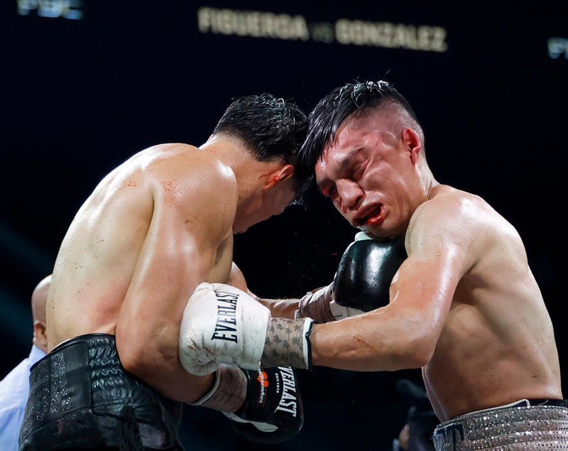 Joet Gonzalez takes a punch from Brandon Figueroa during their featherweight bout.