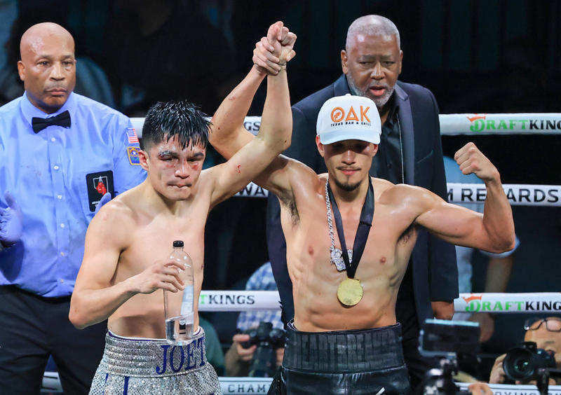 Joet Gonzalez (left) and Brandon Figueroa pose in the ring after Gonzalez won their featherweight bout by unanimous decision.
